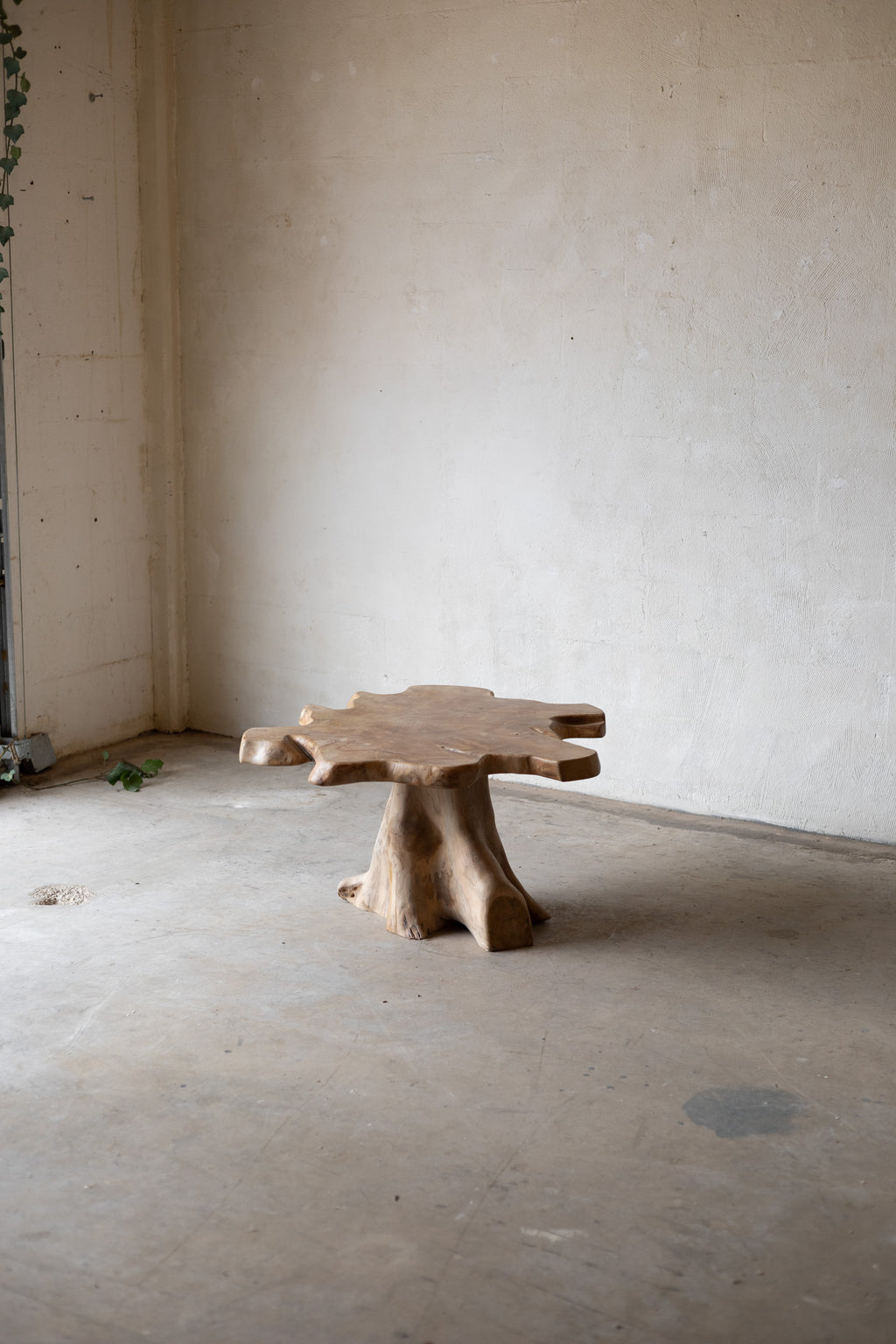 Wooden table with a natural, rustic design in an empty room.