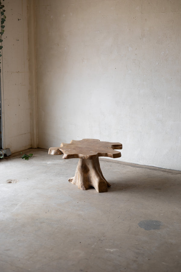 Wooden table with a natural, rustic design in an empty room.