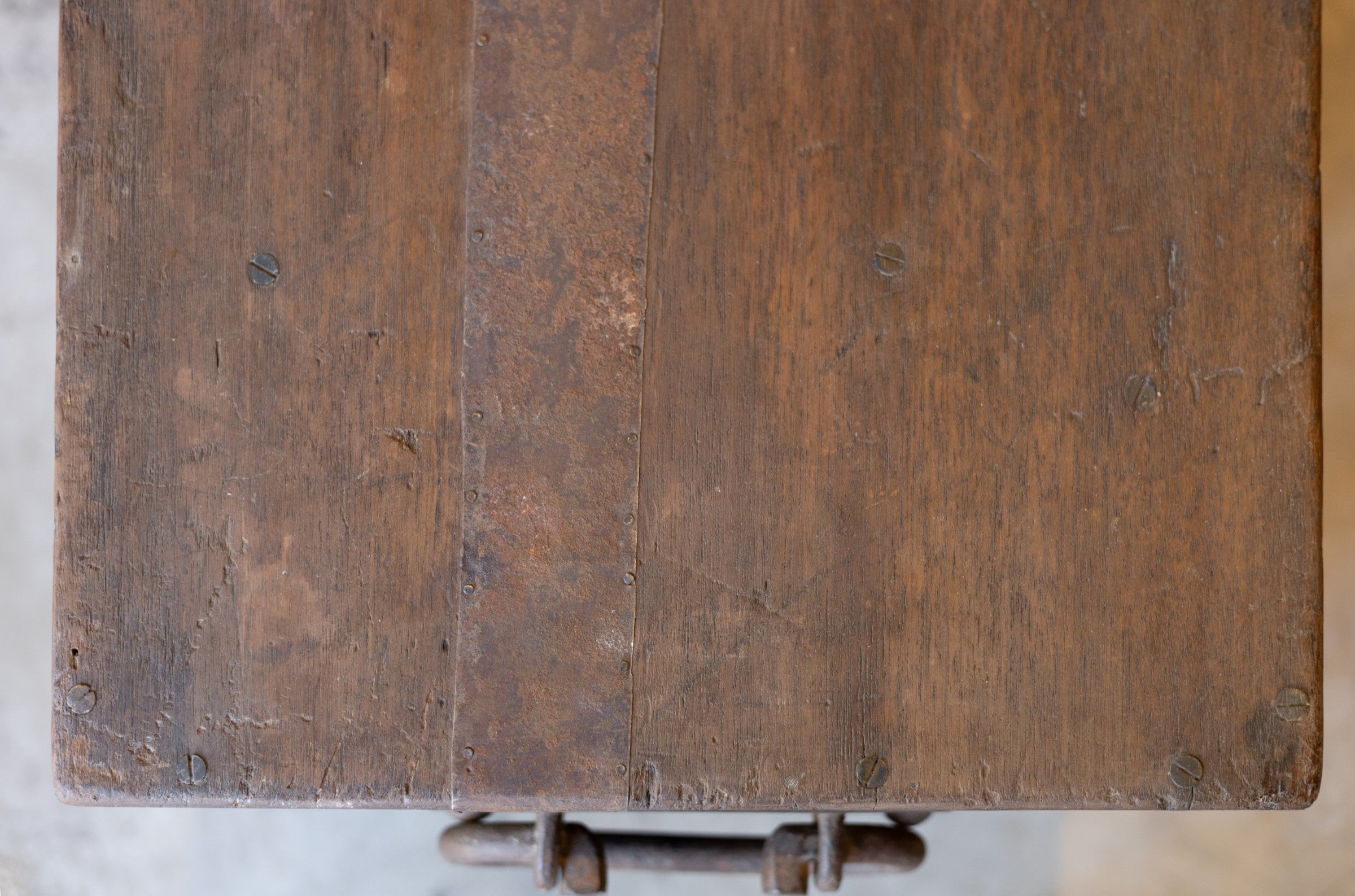 Close-up of a wooden surface of vintage teak coffee table with visible grain and texture from above.