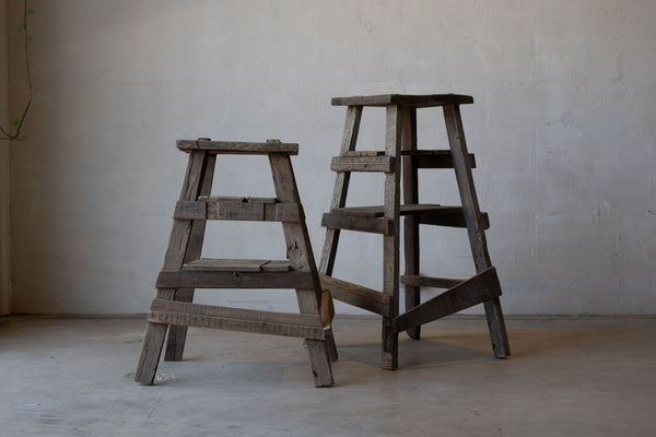 Pair of rustic wood painter stools of different heights. 