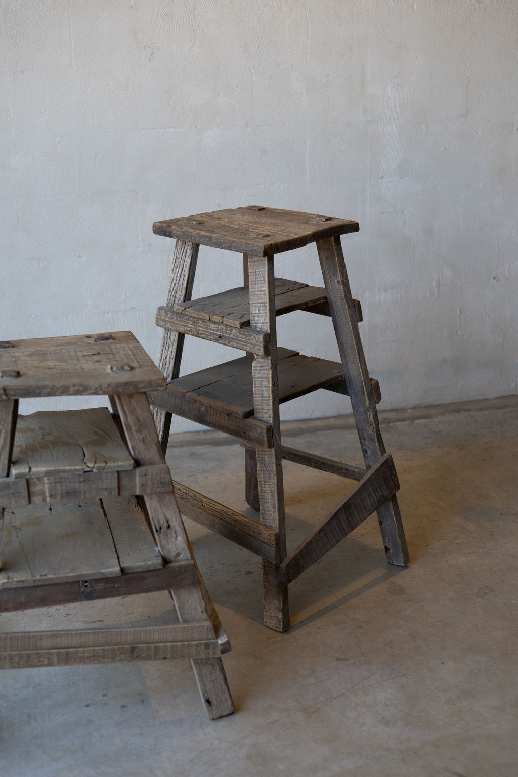 Pair of rustic wood painter stools of different heights. 