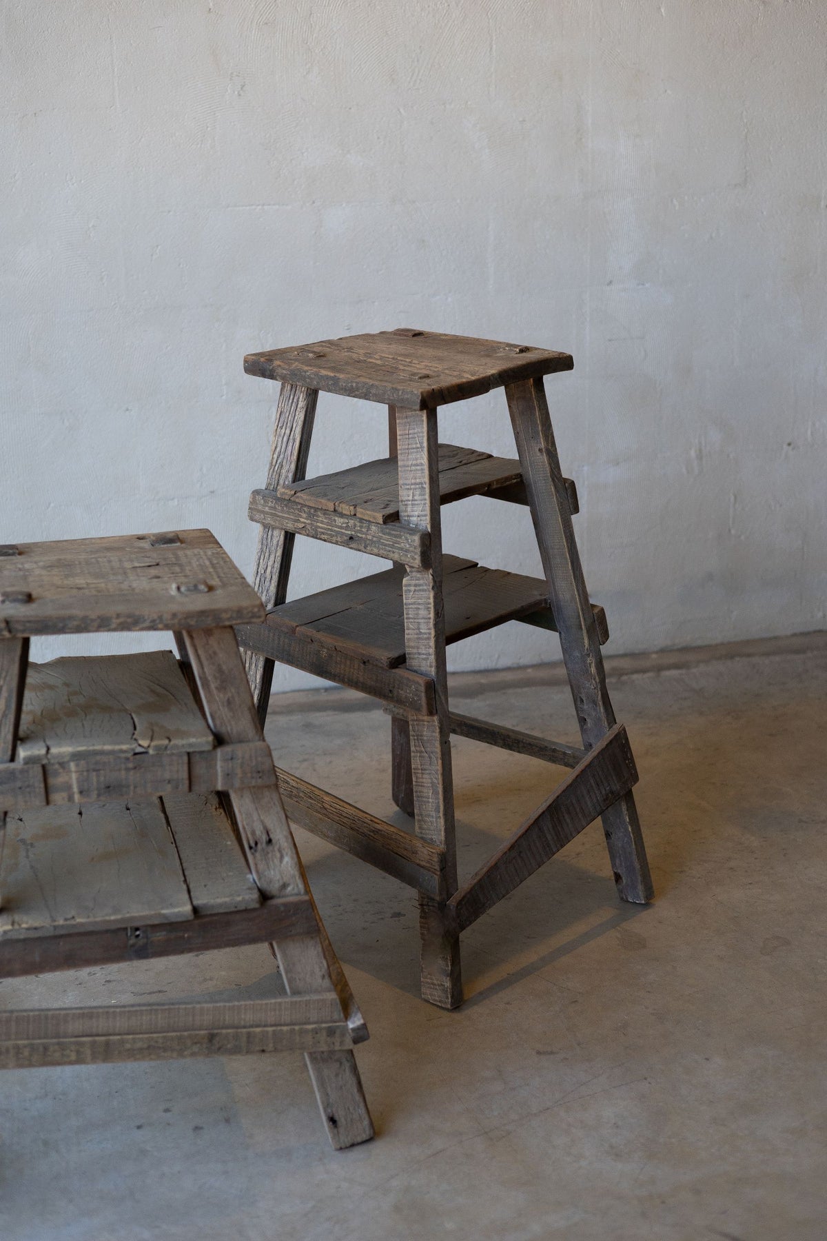 Pair of rustic wood painter stools of different heights. 