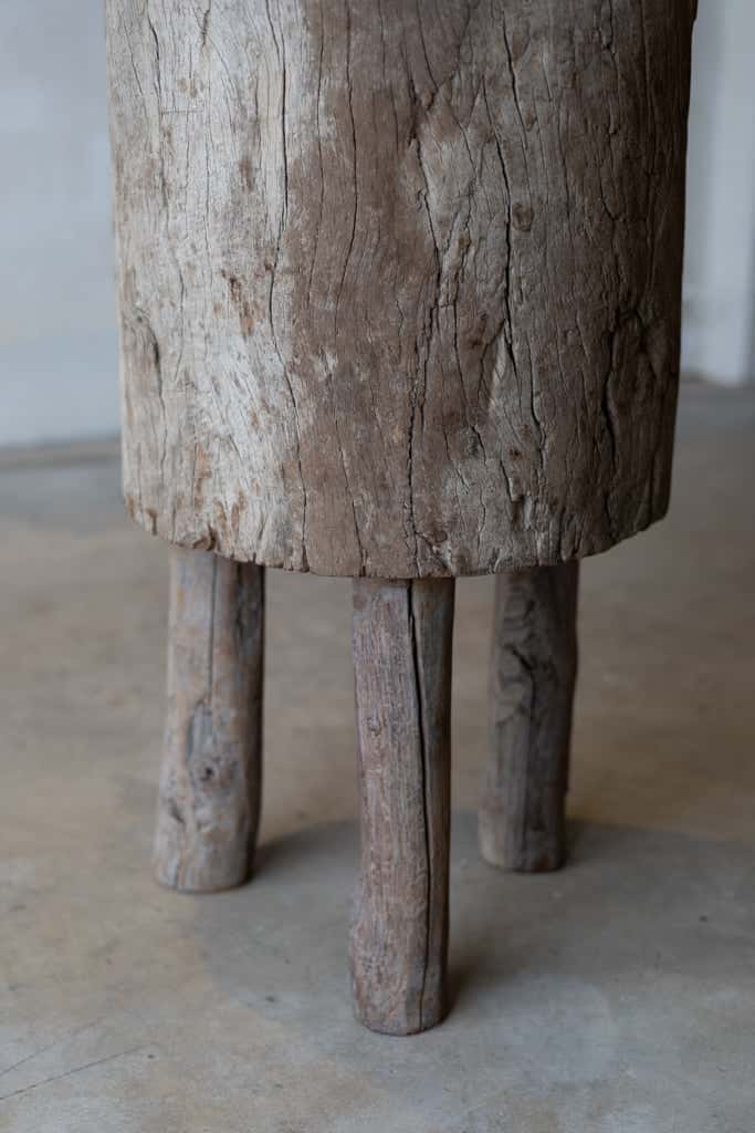 Detail of butcher block table, showing rustic wooden legs .