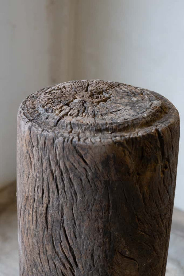 Close-up of butcher block table top with natural rings and wear. 