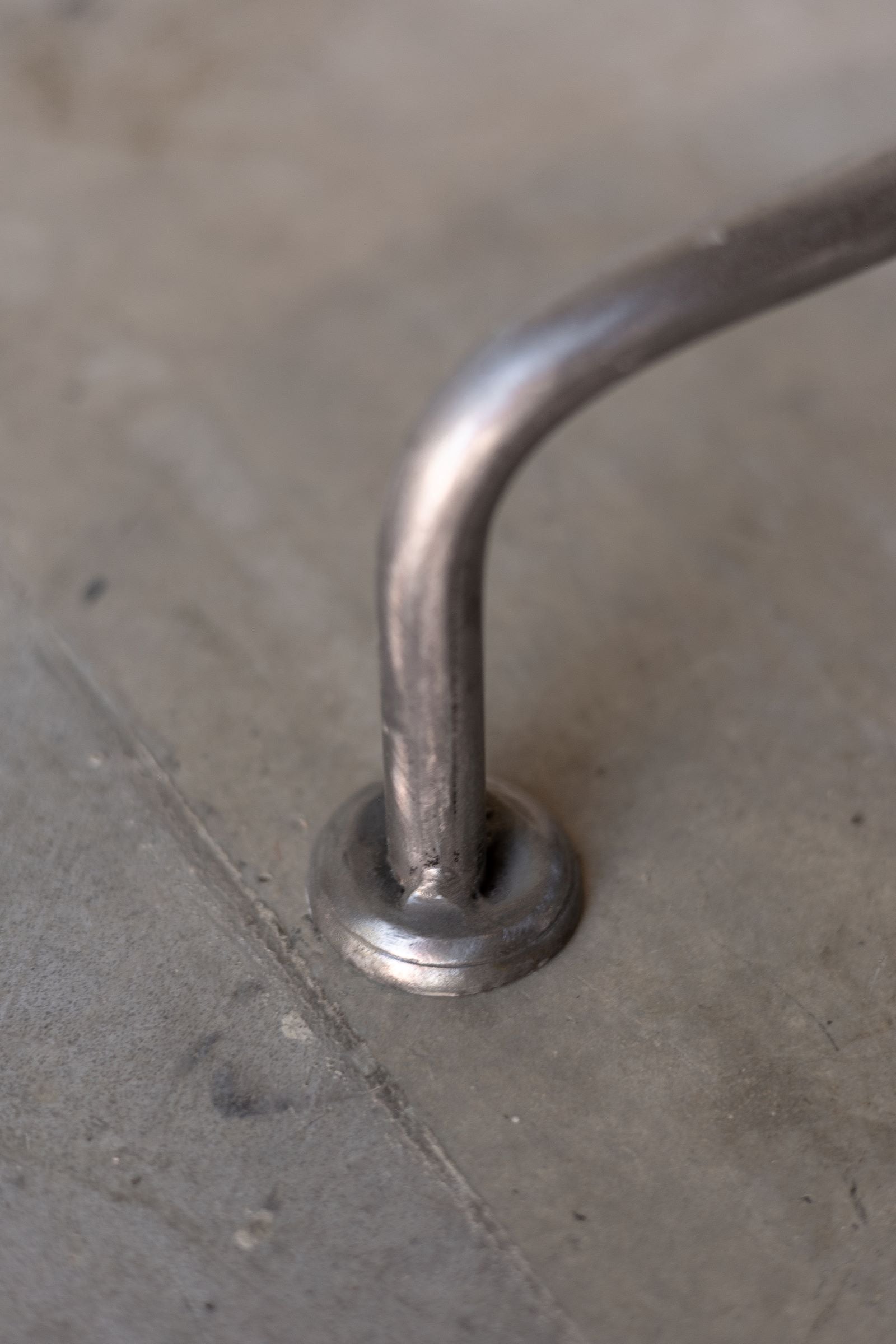Close up view of Englishman side table leg with rounded foot. 