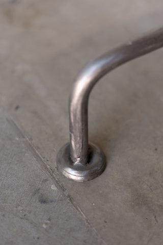 Close up view of Englishman side table leg with rounded foot. 