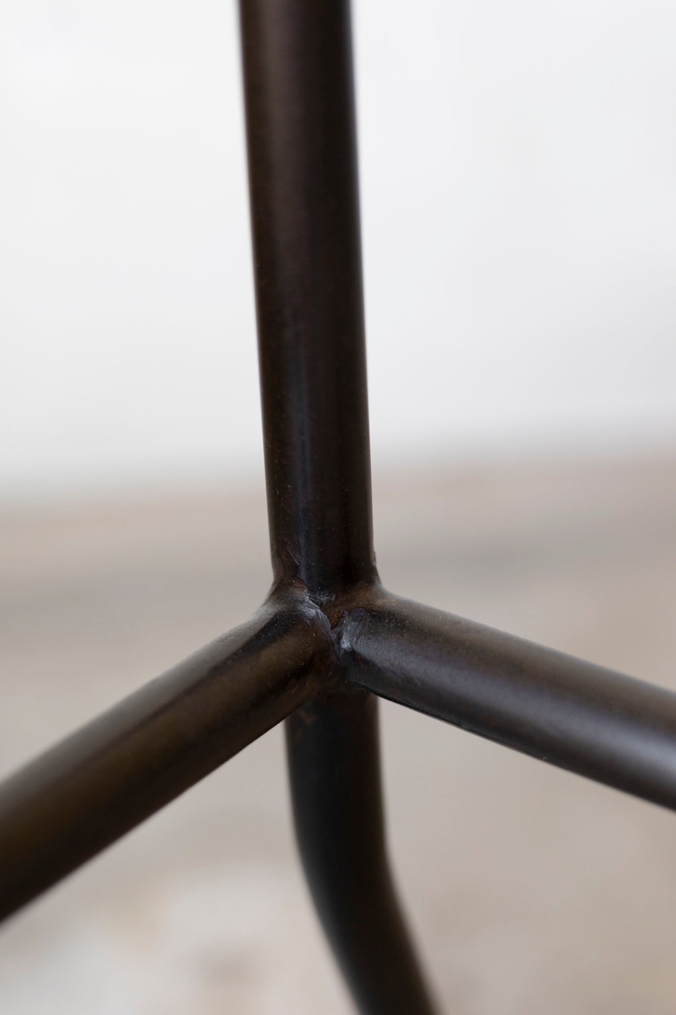 Close-up of a black metal frame with a blurred background