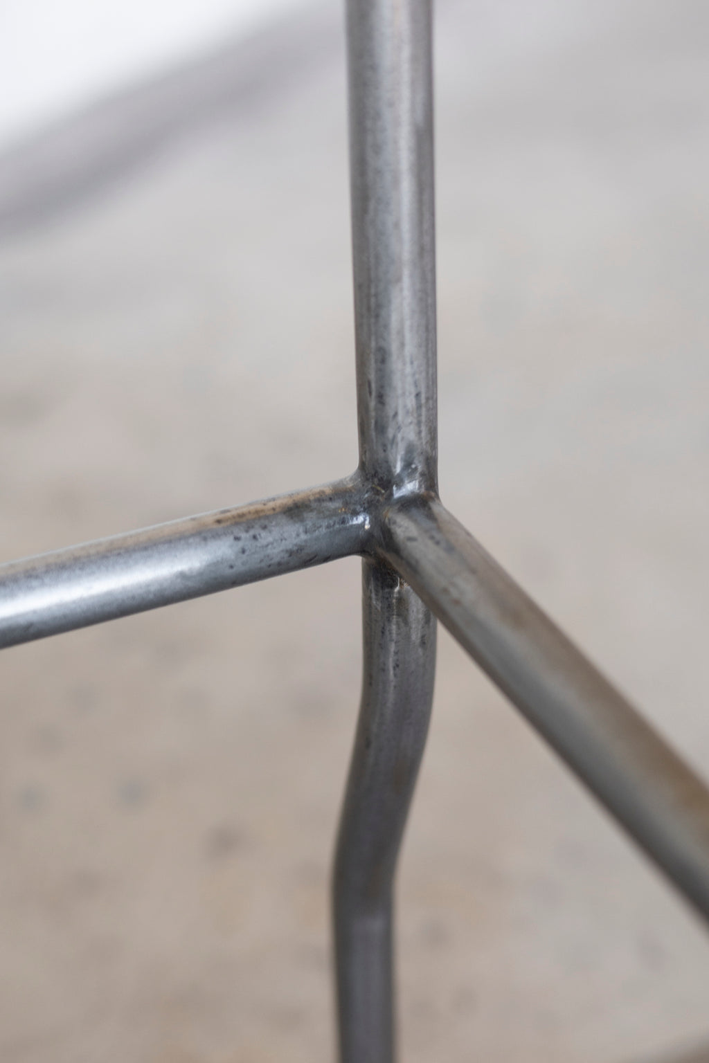 Close-up of a metal grid structure with a blurred background