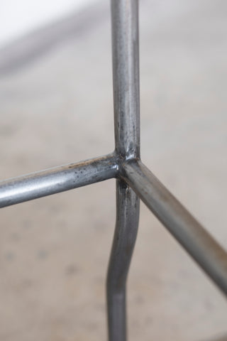 Close-up of a metal grid structure with a blurred background