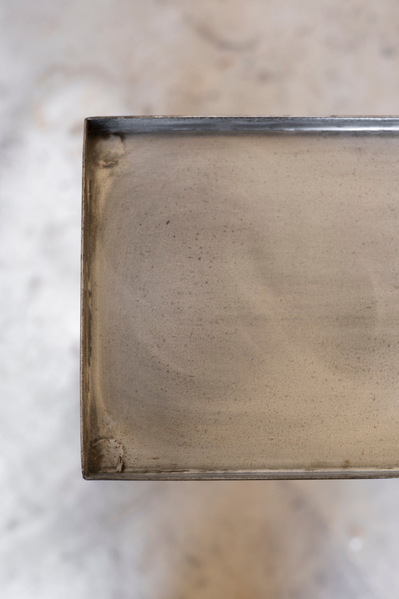 Close-up of a metallic object on a textured surface