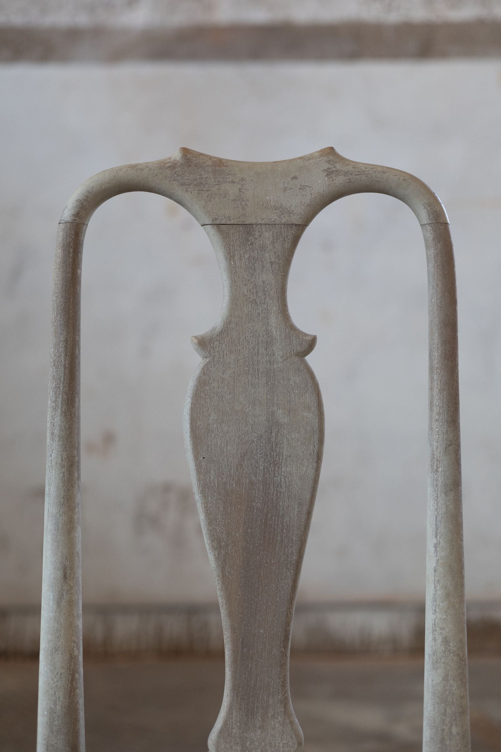 Back of vintage dining chair with arches.