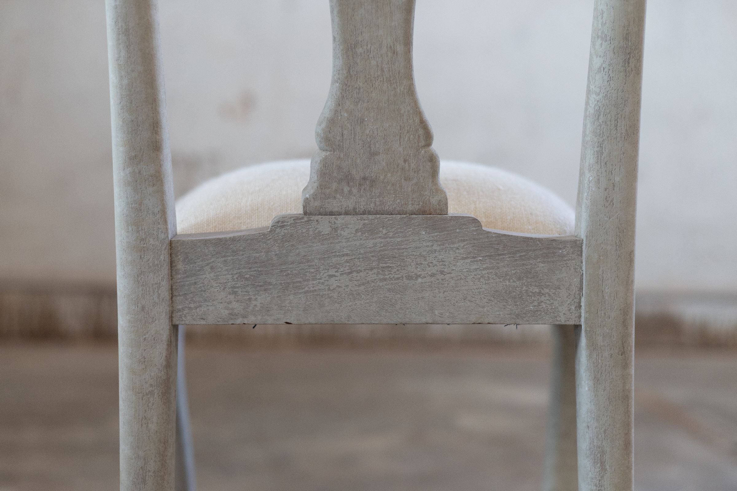 Close-up of the back of a chair with a blurred background