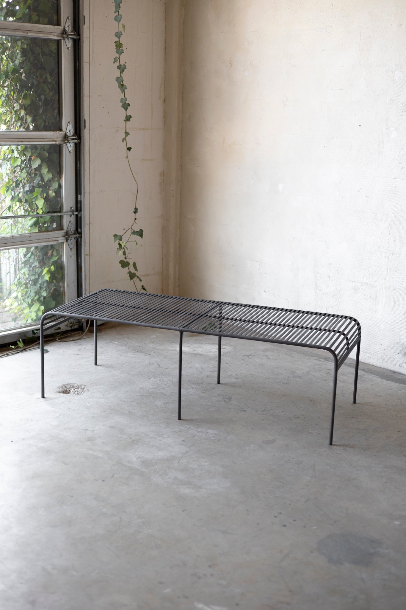 Metal coffee table with a minimalist design on a plain background