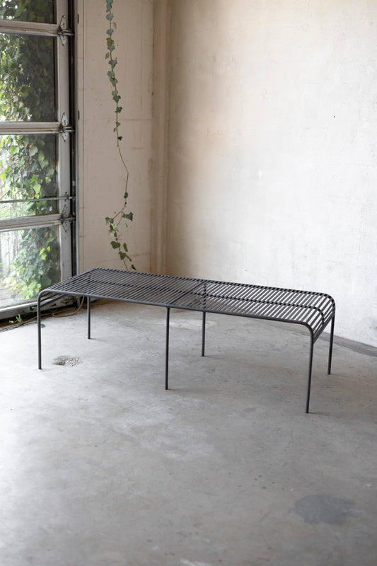 Metal coffee table with a minimalist design on a plain background
