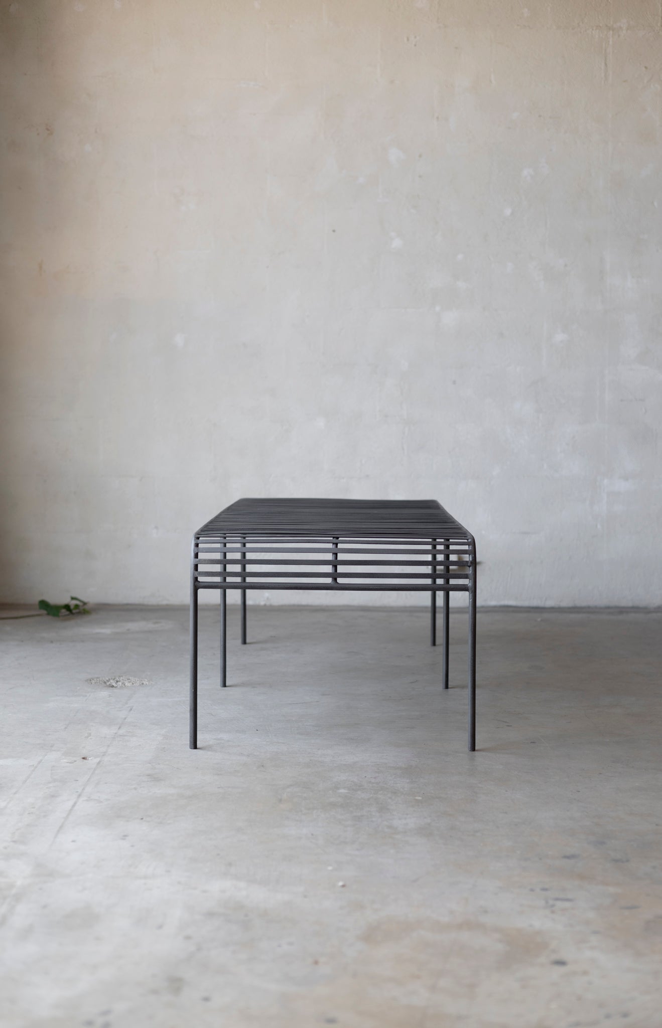 Metal coffee table with a minimalist design on a plain background