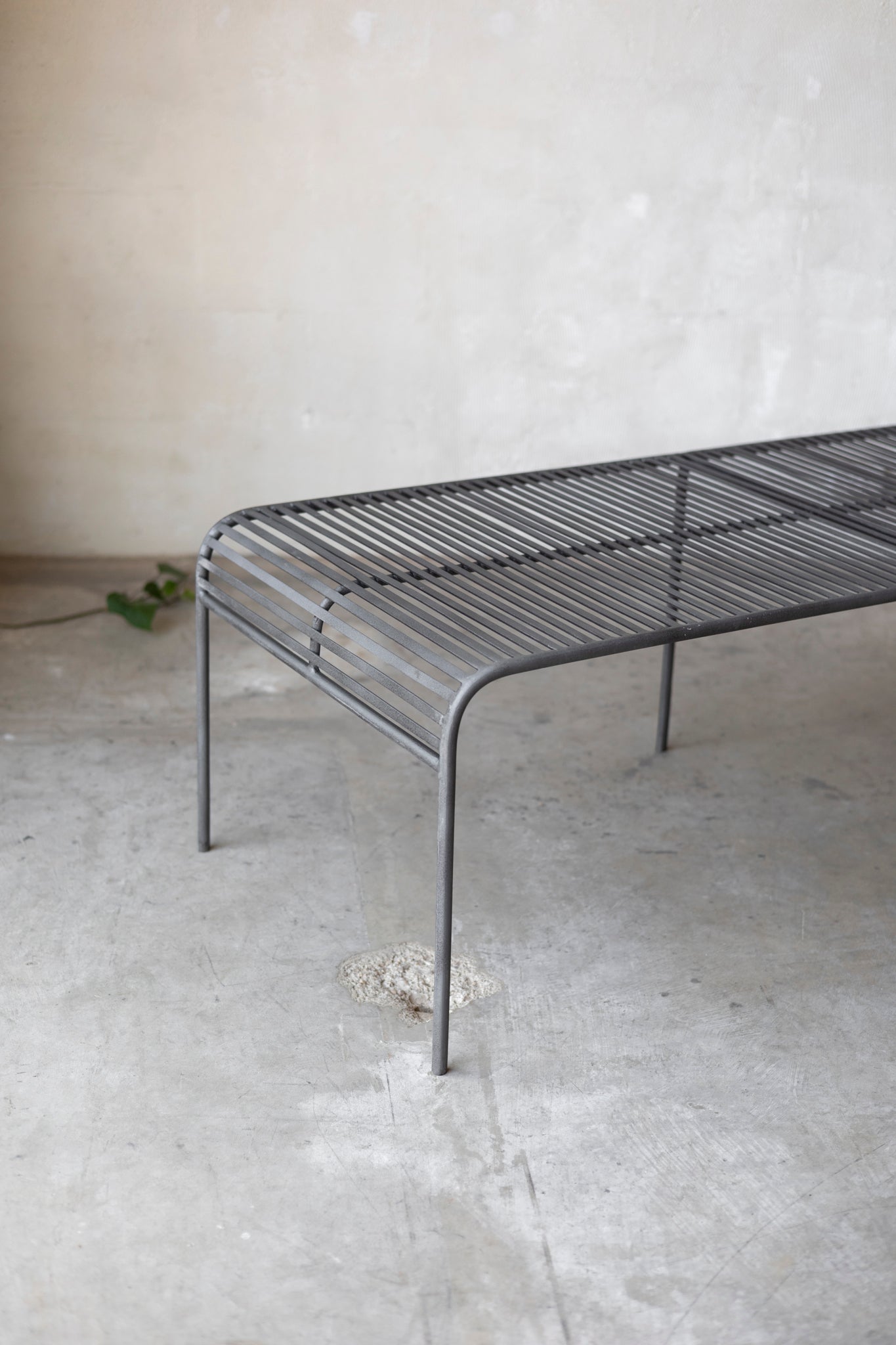 Metal coffee table with a minimalist design on a plain background