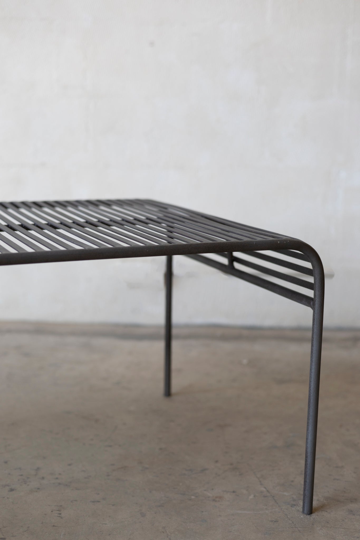 Metal coffee table with a minimalist design on a plain background