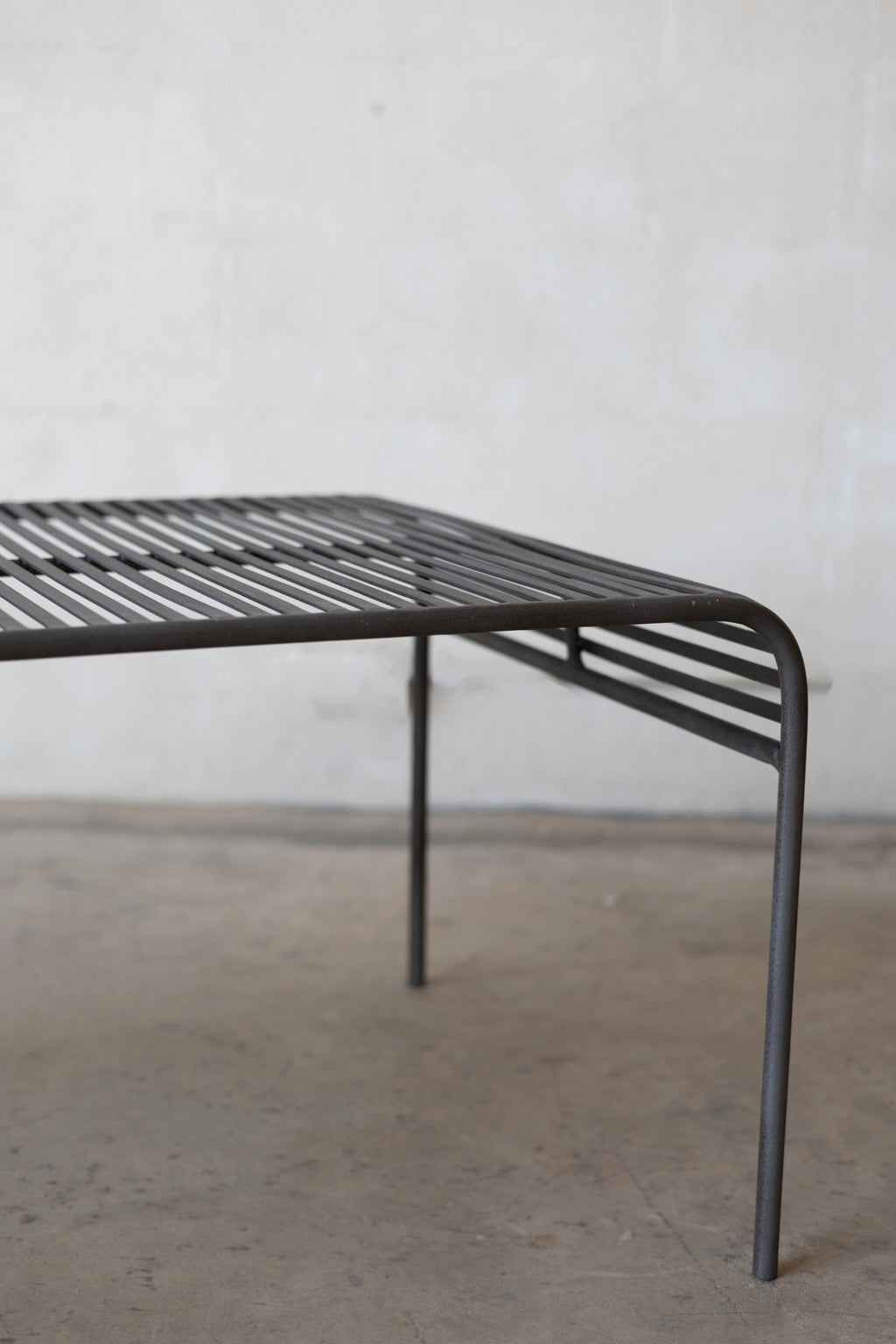 Metal coffee table with a minimalist design on a plain background