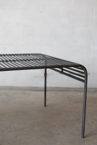 Metal coffee table with a minimalist design on a plain background