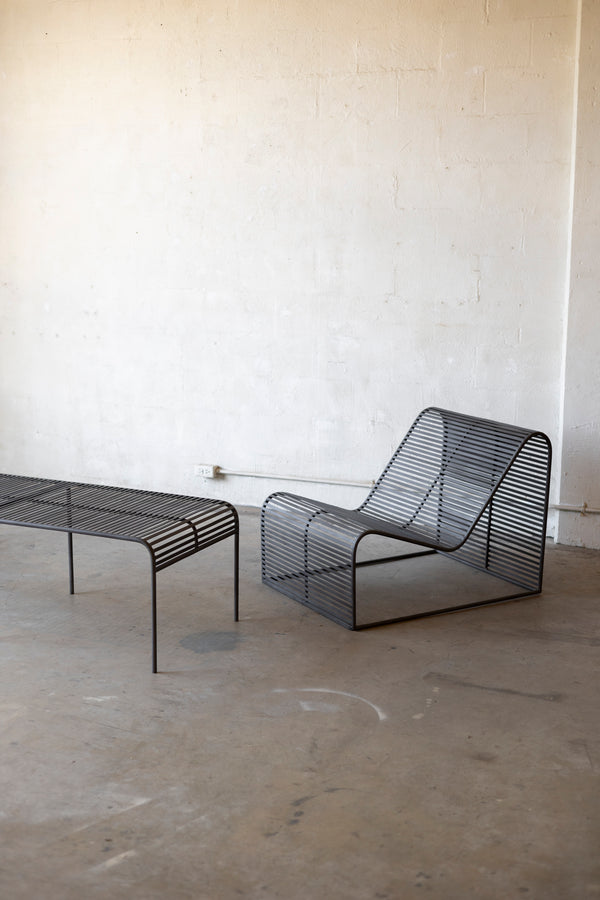 Wave Coffee Table paired with the Wave Chairs on a concrete surface