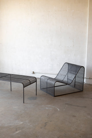 Wave Coffee Table paired with the Wave Chairs on a concrete surface