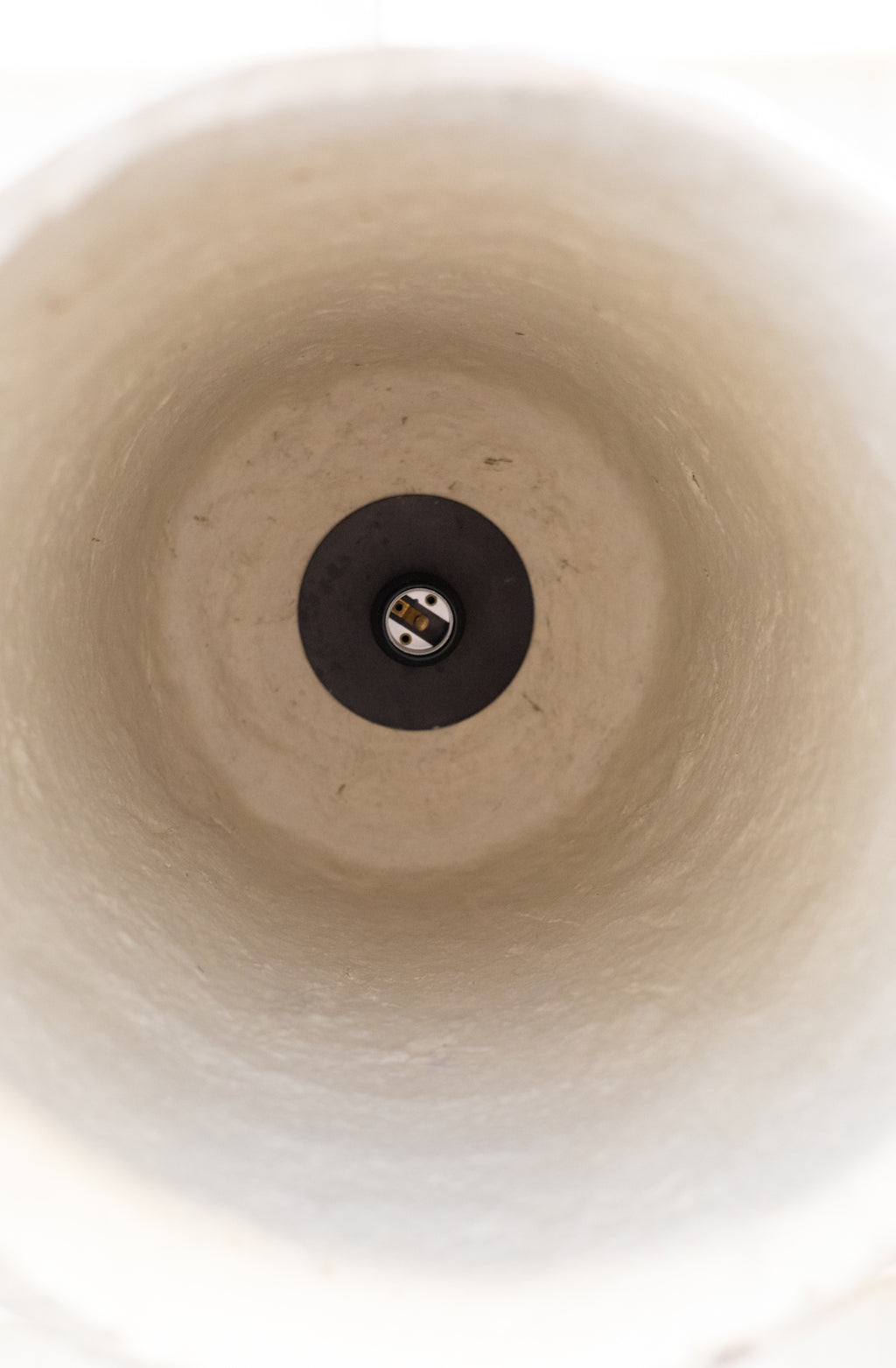 Close-up of the inside of textured white pendant light. 