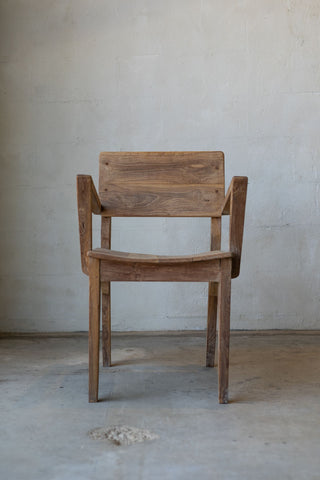 Antique art deco wood dining chairs with angled arm rests.