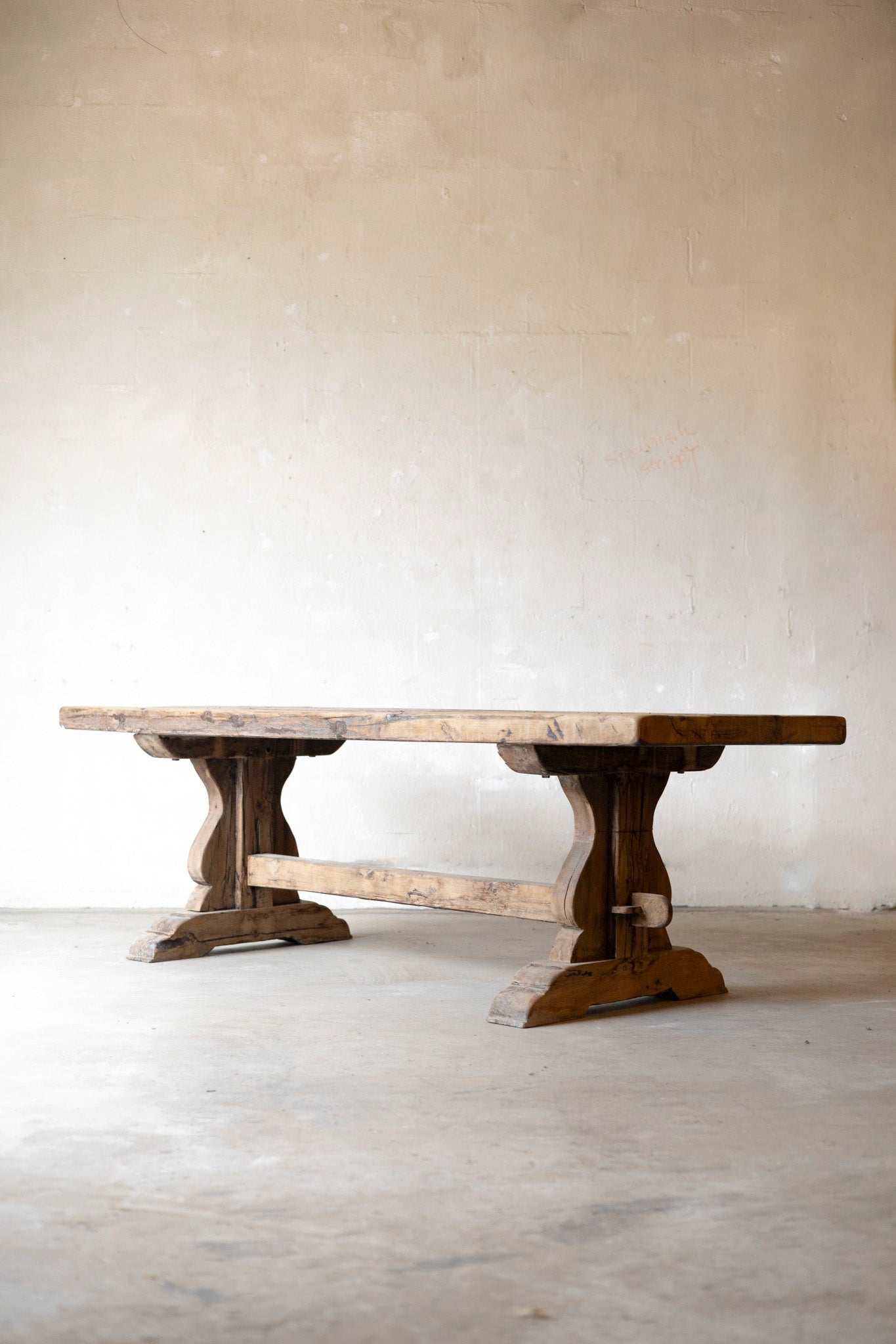 Wooden dining table with marble top on a plain background
