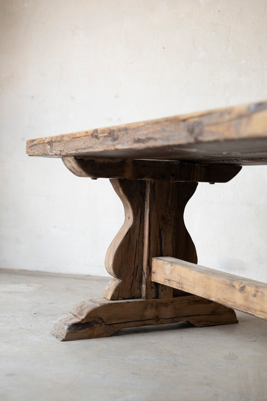 Wooden table with rustic design on a plain background