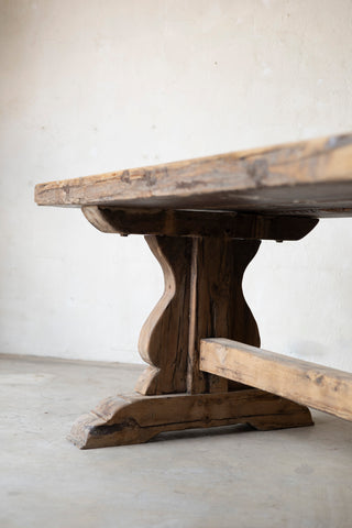 Wooden table with rustic design on a plain background