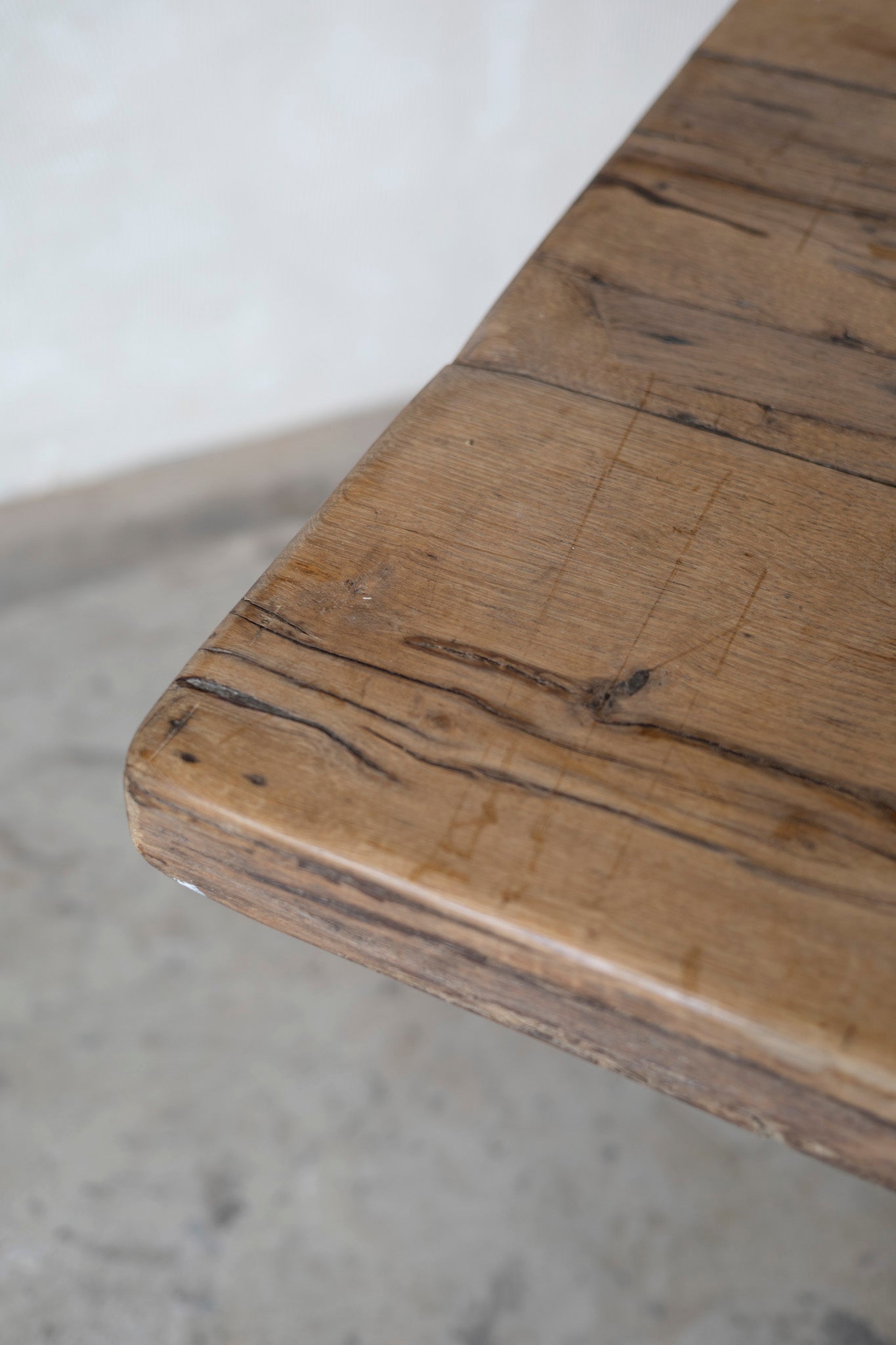 Close-up of a wooden table with visible grain and texture.