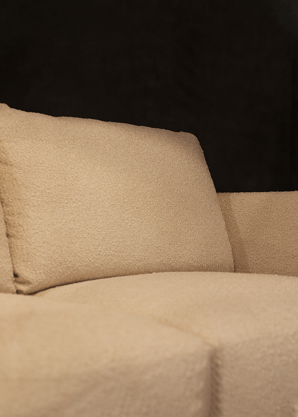 a close up of a couch with a pillow on it