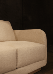 a white couch sitting on top of a wooden floor