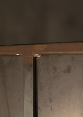 a close up of a metal cabinet with a screw in it