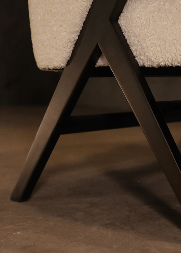 a close up of a white chair with a black frame