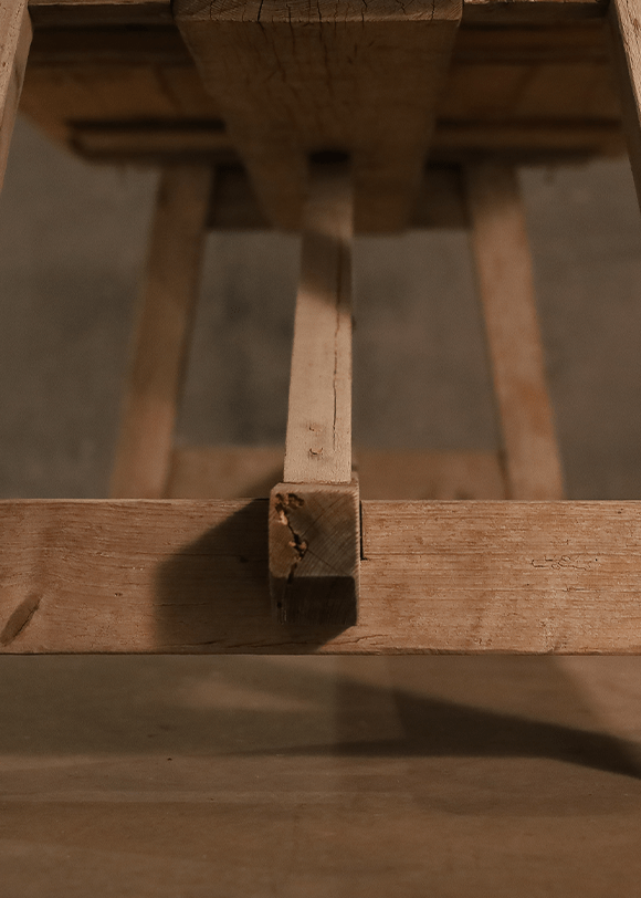 a close up of a wooden table with a piece of wood sticking out of it