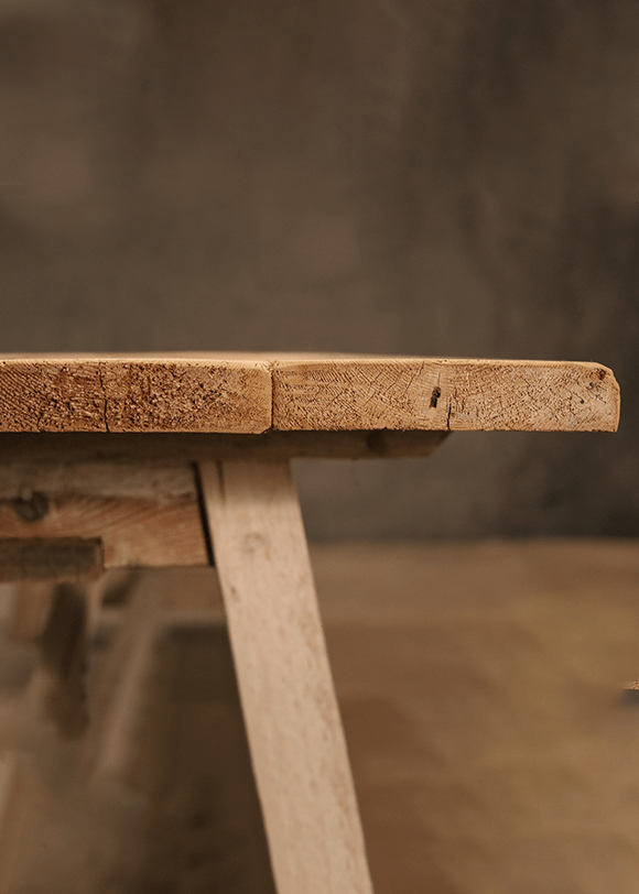 a close up of a wooden bench on a table