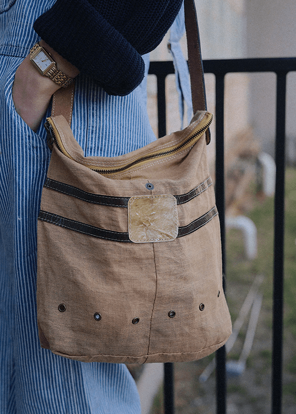 a woman holding a brown purse on her arm