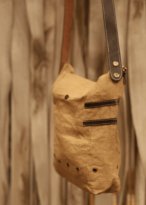 a brown bag hanging from a hook on a wall