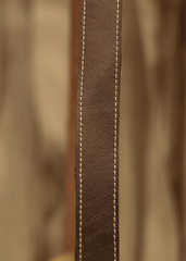 a close up of a brown leather chair