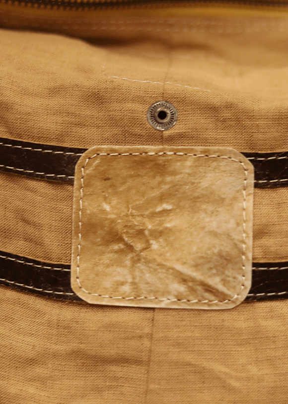 a close up of a bag with a leather tag