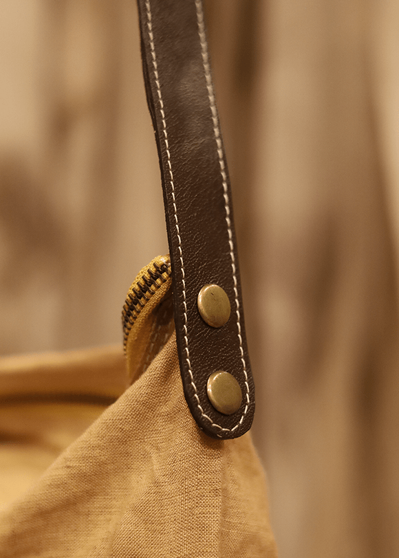 a close up of a bag with a leather handle