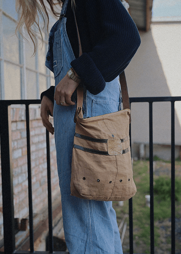 a woman carrying a brown bag on her back