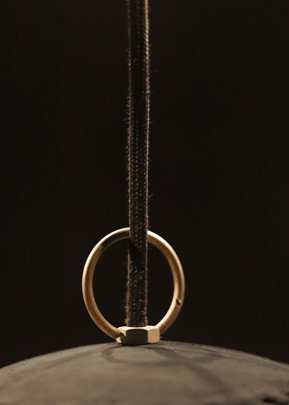a metal object with a ring hanging from it