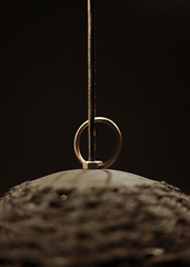 a close up of a ring hanging from a string