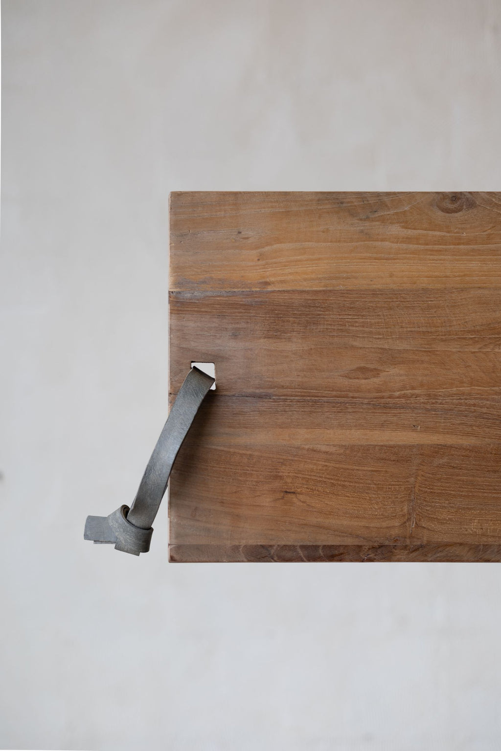 Teakwood cheese board with leather strap. 