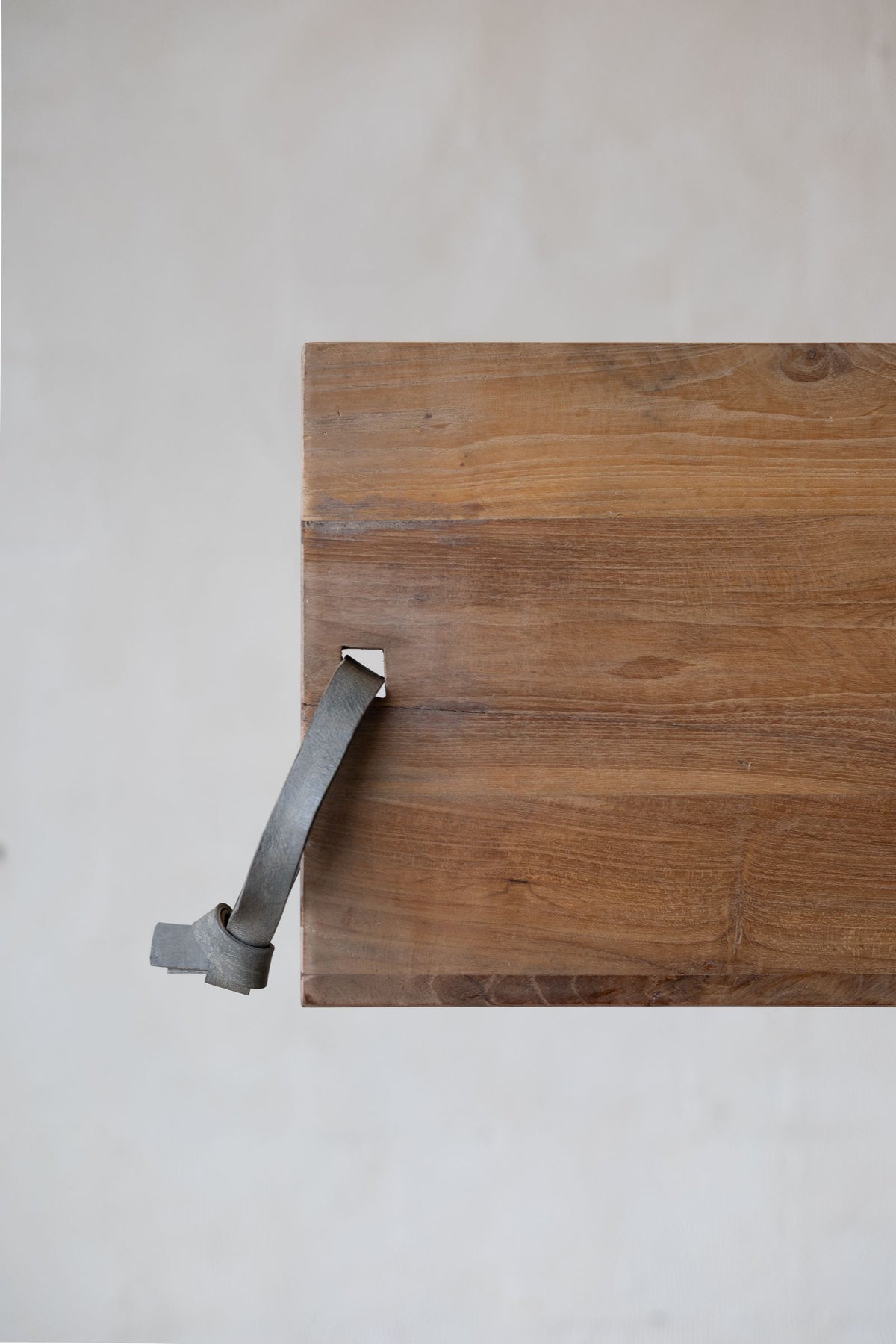 Teakwood cheese board with leather strap. 